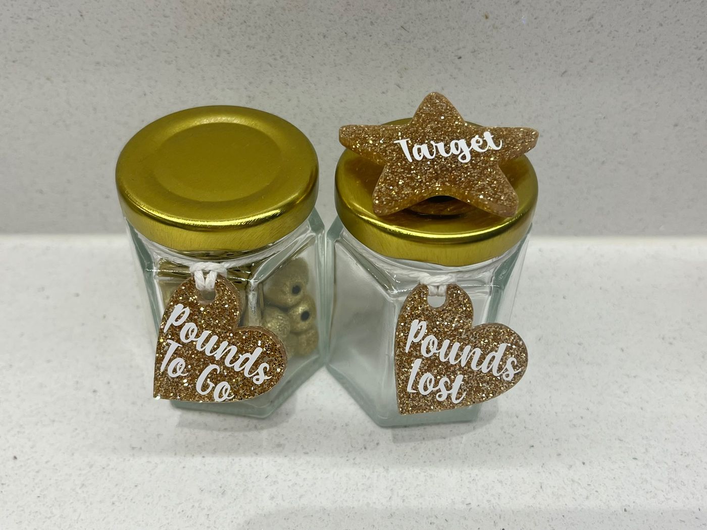 Gold weight loss motivation bead jars: Pounds To Go and Pounds Lost with glitter heart tags and a Target star